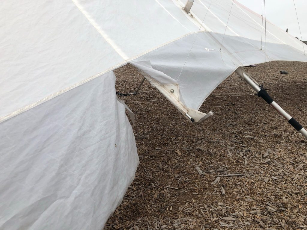 torn Dacron hang glider sail in need of repair